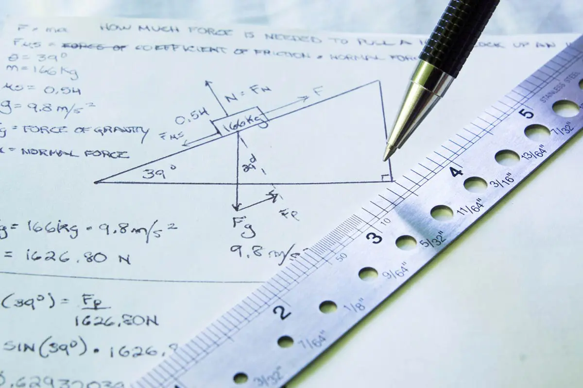 115-02-illustration-of-newtons-second-law-oliver-perez-dreamstime-27278808-1536x1024 A pen and ruler on a piece of paper with calculations